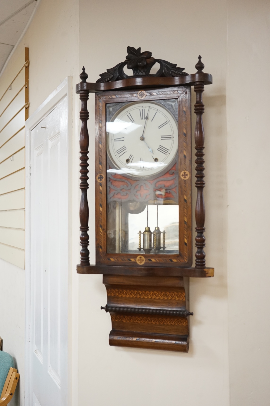 A German inlaid walnut wall clock, 84cm high, with pendulum.
